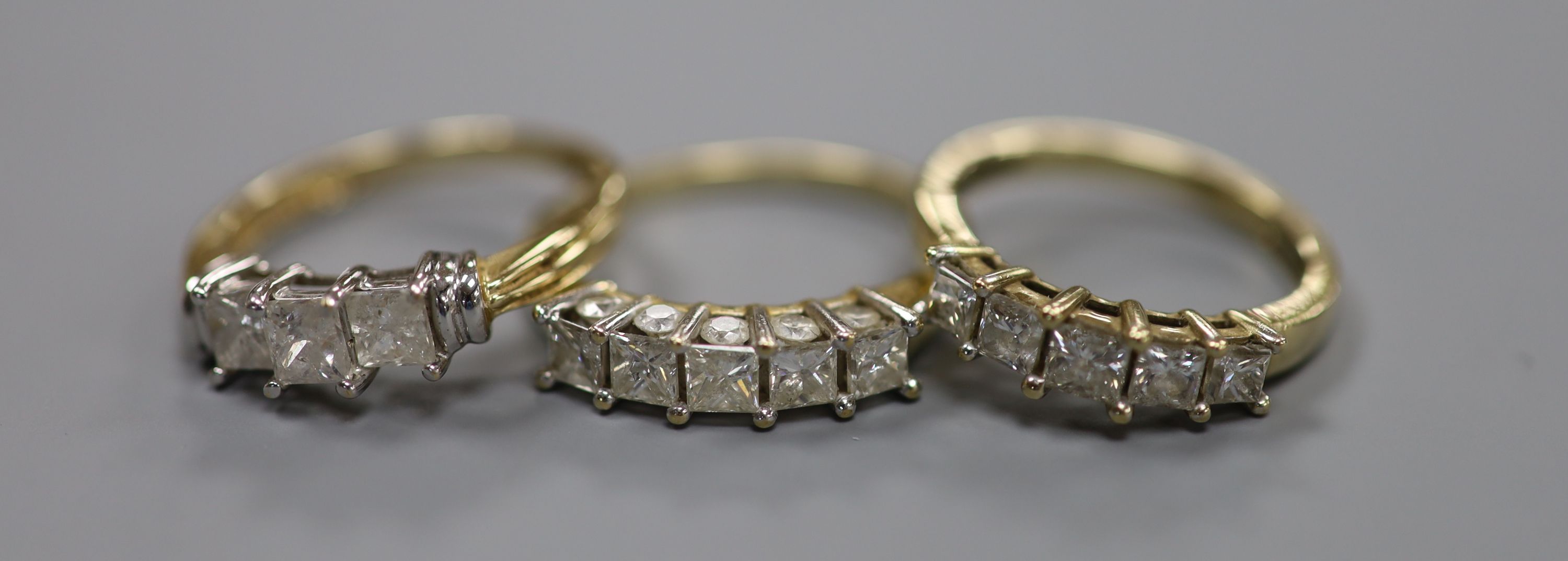 Two modern 9ct gold and five stone diamond set half hoop rings, sizes N & R/S gross 6.4 grams and a similar 14ct gold and three stone diamond ring, size P, gross 2.7 grams.